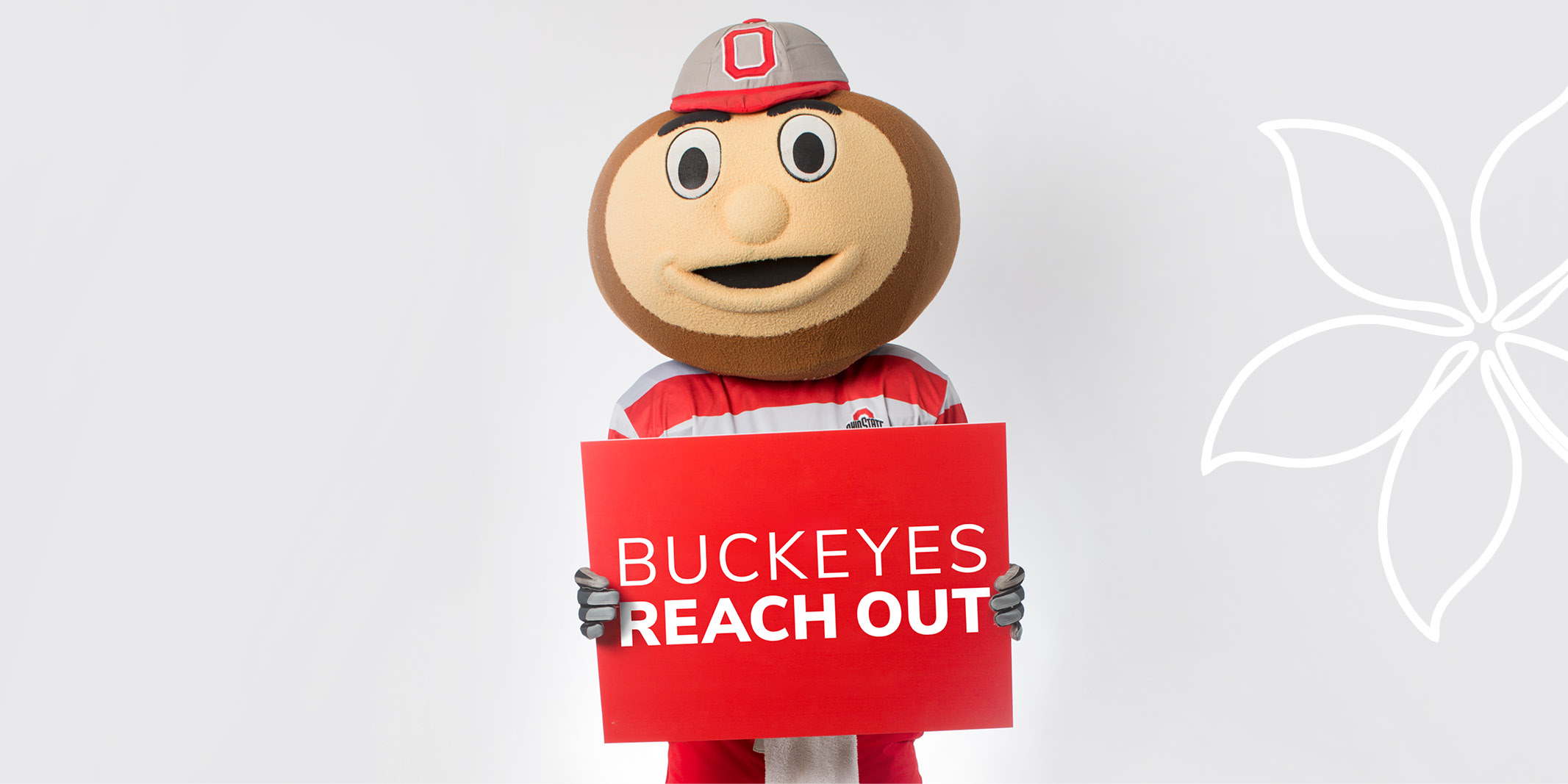 Brutus Buckeye holding a sign that says, "Buckeyes Reach Out."
