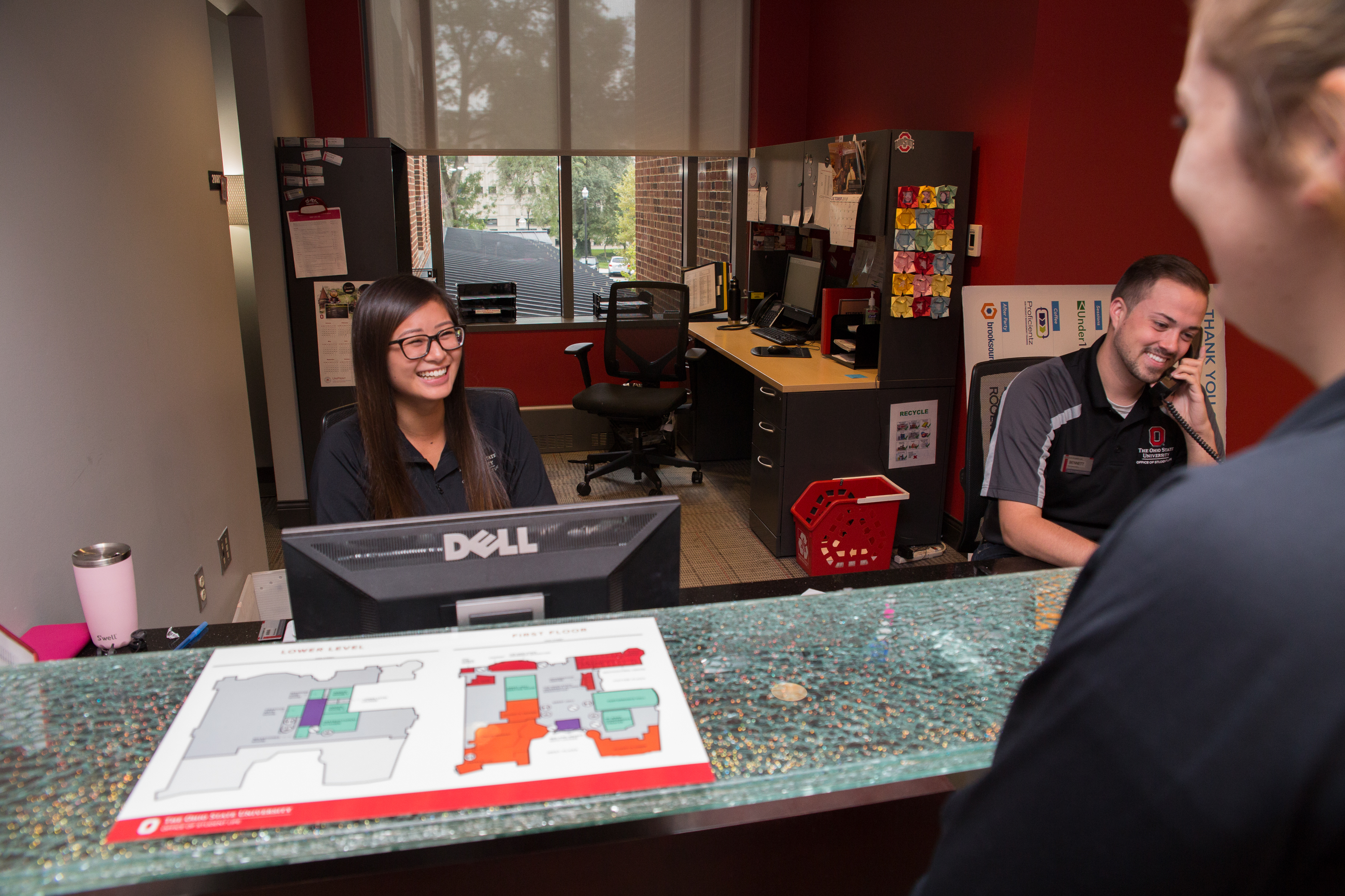 Students helping visitors at the administration desk in the Ohio Union.