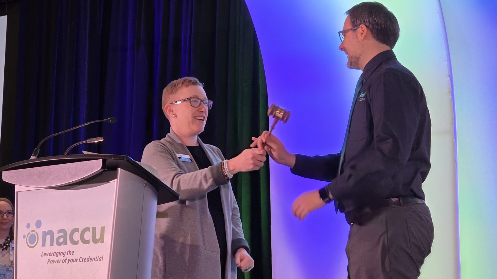The president of NACCU hands the gavel to Josh Bodnar