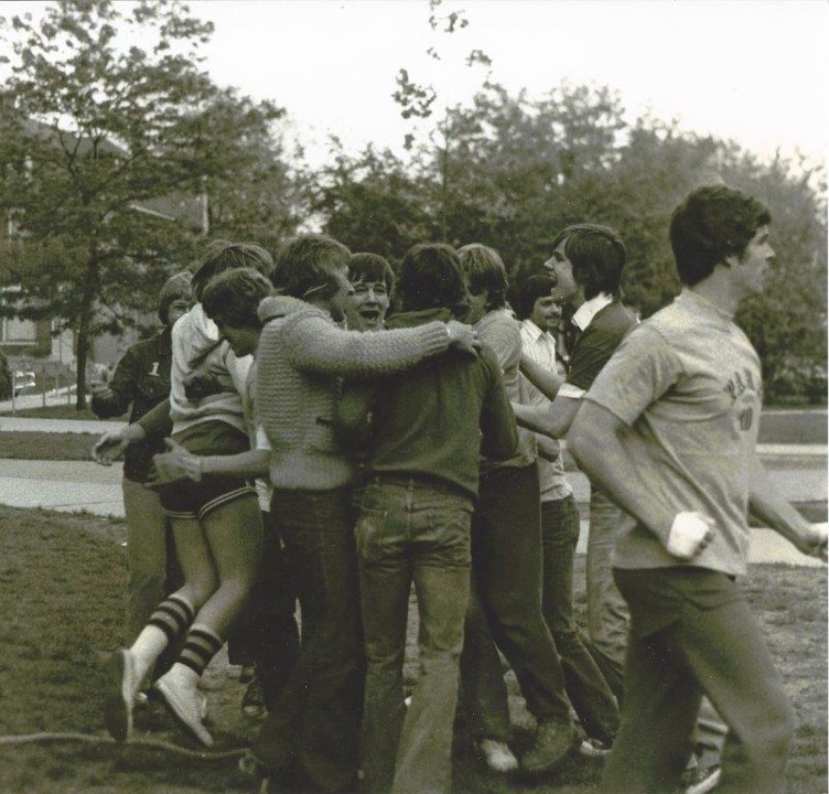 Winners of the tug-of-war competition celebrate with one another.